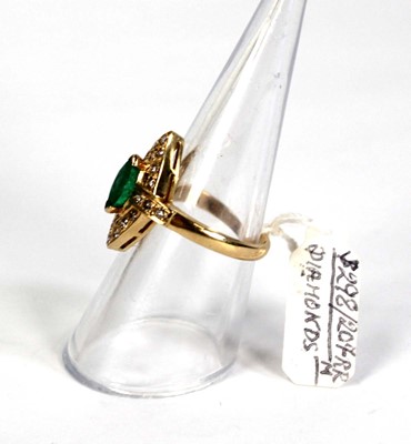 Lot 785 - An 18ct yellow gold ring set emerald and small...