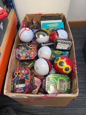 Lot 1931 - Box containing empty Pokémon collectable tins