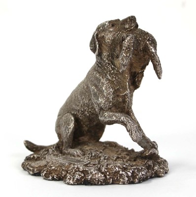Lot 201 - A silver figure modelled as a gun dog and its...