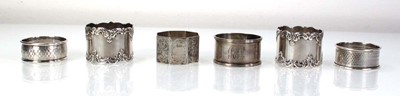 Lot 217 - Six silver napkin rings, various designs,...