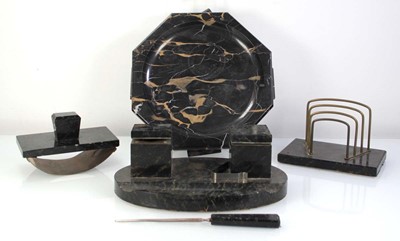 Lot 60 - An Art Deco black marble/hardstone four piece...