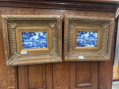 Lot 33 - Two blue and white hunting scenes on tiles in...