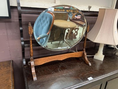 Lot 46 - An oak framed oval swing mirror