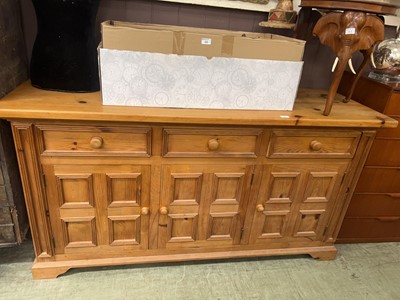 Lot 62 - A pine dresser base with three drawers over...