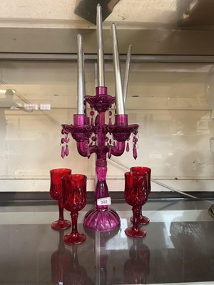 Lot 302 - A modern pink glass four branch candelabrum...