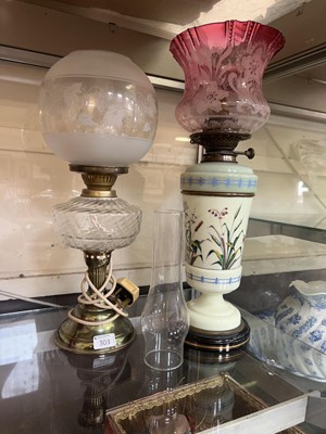 Lot 303 - A brass and glass oil lamp along with a green...
