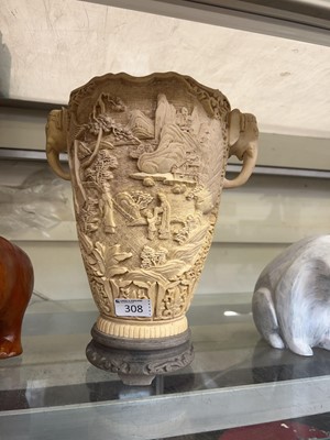 Lot 308 - An oriental resin vase with elephant handles...