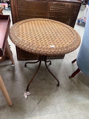 Lot 83 - A woven rattan topped metalwork garden table