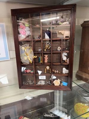 Lot 372 - A modern display case containing assorted...