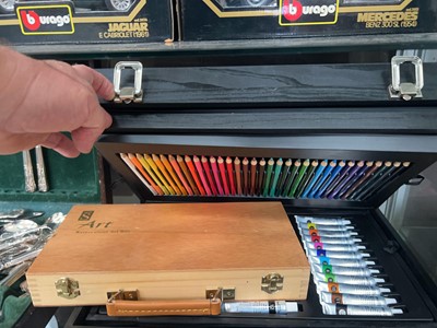 Lot 380 - A black wooden artist's box containing pens,...