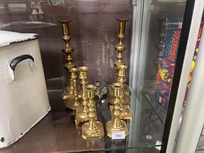 Lot 390 - Four pairs of brass candlesticks along with...