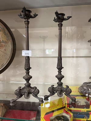 Lot 395 - A pair of ornate cast metal candlesticks with...