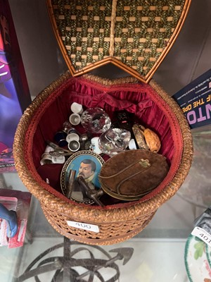 Lot 400 - A small lined wicker basket containing...