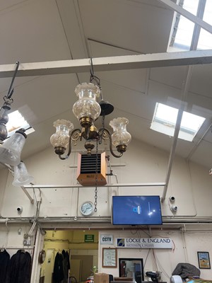 Lot 102 - A metal and glass three branch light fitting