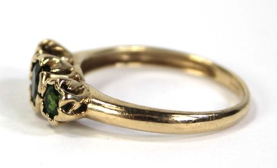 Lot 797 - A 9ct yellow gold ring set three graduated...
