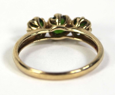 Lot 797 - A 9ct yellow gold ring set three graduated...
