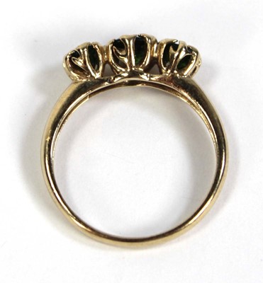 Lot 797 - A 9ct yellow gold ring set three graduated...