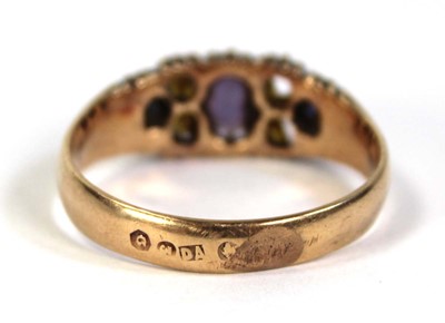 Lot 798 - A yellow metal ring set three graduated blue...