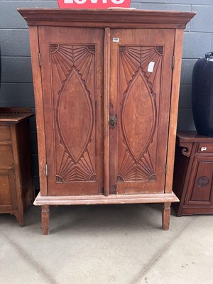 Lot 5129 - Double door hardwood cupboard with carved panels
