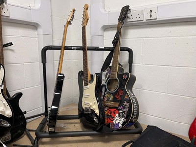 Lot 2303 - Guitar rack with three guitars