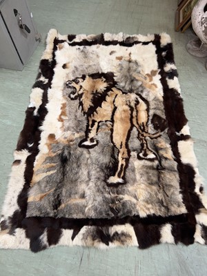 Lot 99 - A patchwork fur rug with lion decoration