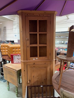 Lot 104 - A pine corner cabinet with cupboards