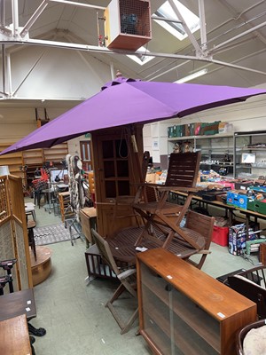 Lot 106 - A teak folding garden table with three...