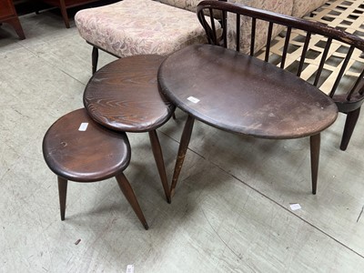 Lot 110 - Set of three dark Ercol pebble tables