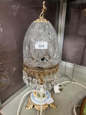 Lot 304 - A metal and glass table lamp with ceramic...