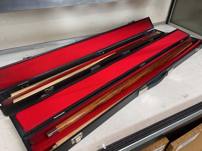 Lot 325 - Two cased snooker cues, one by Riley the other...