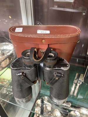 Lot 352 - Cased pair of military marked binoculars,...