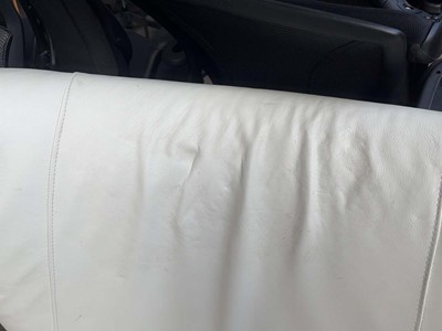 Lot 61 - Conran Content white leather wingback armchair...