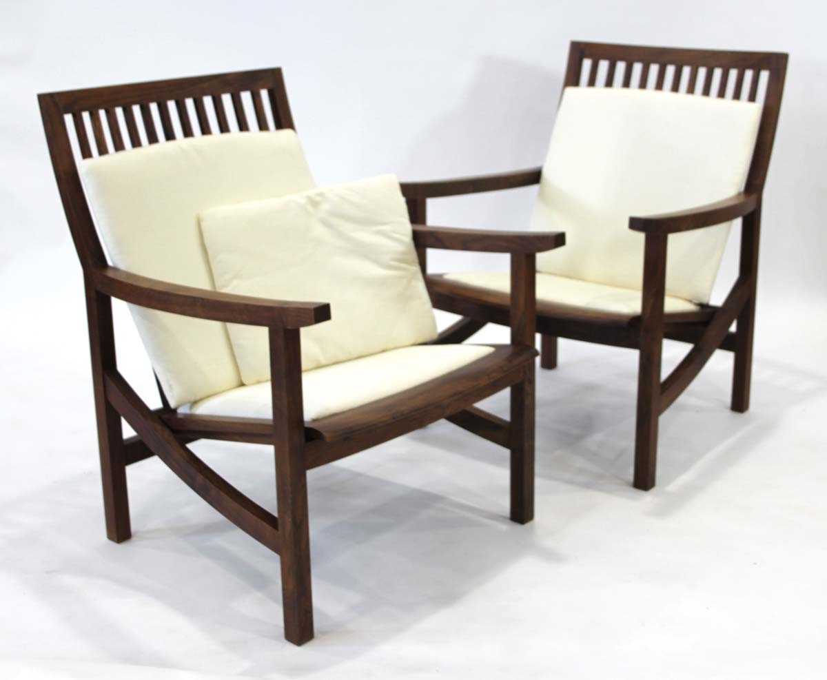 Lot 10 - Pair of walnut executive armchairs designed...