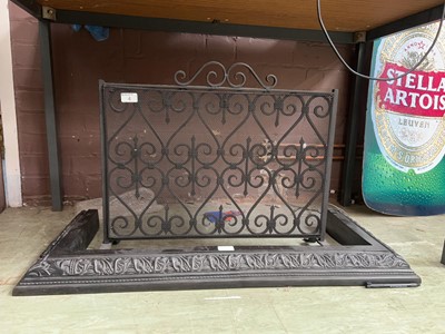 Lot 4 - A black cast metal fire grate along with an...