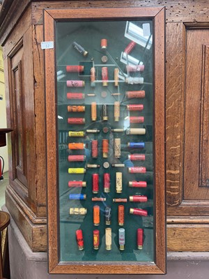 Lot 12 - An oak wall mounted display case of spent...