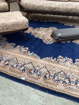 Lot 61 - A large blue ground Persian-style rug with...