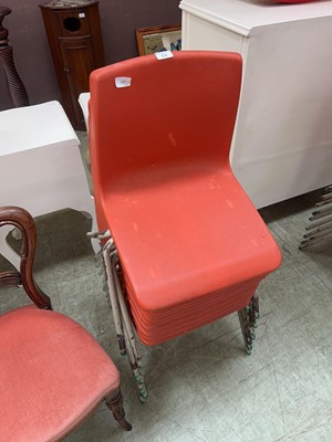 Lot 63 - A collection of 9 stacking PVC chairs in red