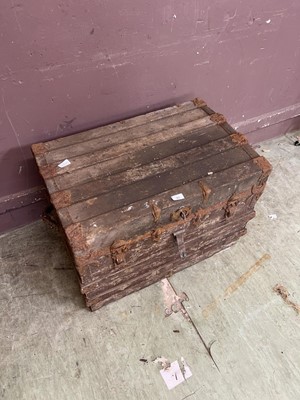 Lot 90 - A weathered wooden-banded travelling trunk...