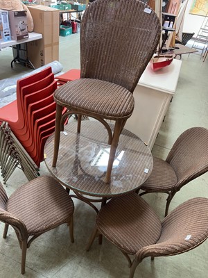 Lot 48 - A Lloyd Loom bistro table along with four...