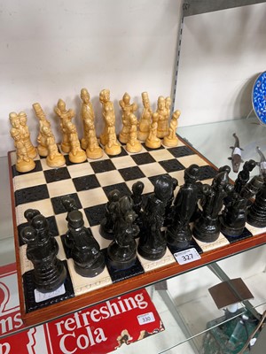 Lot 327 - A wood and moulded chess board along with a...