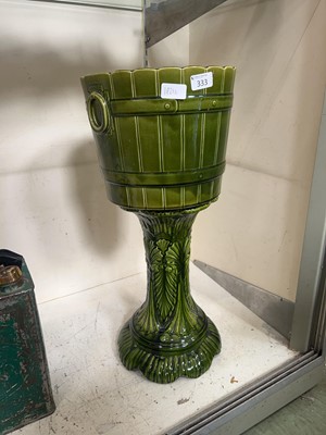 Lot 333 - An embossed green ceramic jardinière stand...
