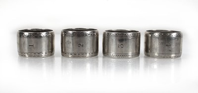 Lot 226 - A set of four George V silver napkin rings,...