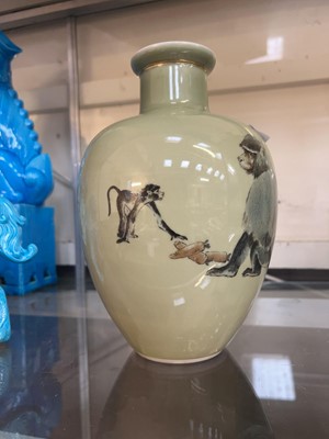 Lot 301 - An oriental green ceramic vase with animal...