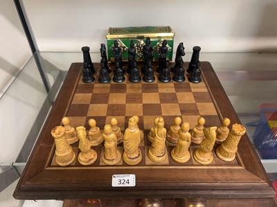 Lot 324 - A wooden chess board with a set of moulded...