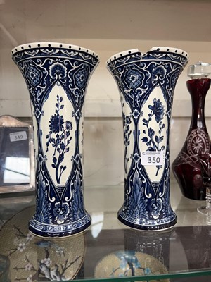 Lot 350 - A pair of blue and white vases with floral...
