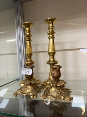 Lot 371 - A pair of brass candlesticks along with a pair...