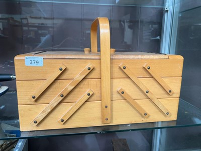 Lot 379 - A modern cantilever sewing box with assorted...