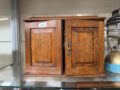 Lot 382 - A 20th-Century oak smokers cabinet, with...