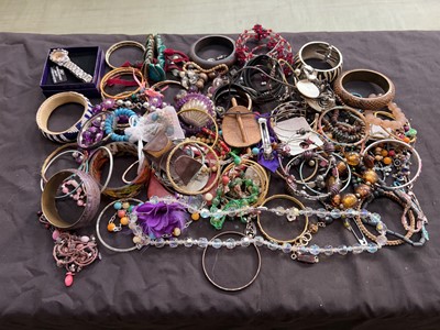 Lot 399 - A tin containing an assortment of costume...