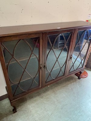 Lot 54 - A mahogany effect bookcase on ball and claw feet